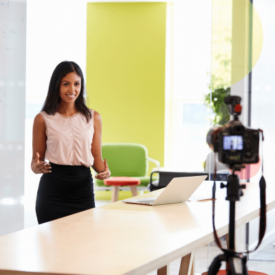 5 types of corporate videos that drive engagement 2 A woman standing in front of a camera, representing the best types of corporate videos
