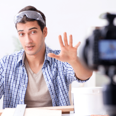 Diy corporate video isn’t worth the risk—here’s why 2 A man with goggles on his head motioning the stop hand gesture at a camera, representing diy corporate video